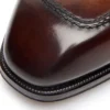 Mocassini Elkan con cinturino intrecciato in pelle brunita